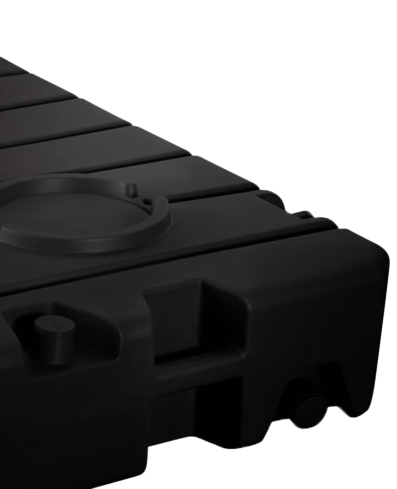Close-up of a black, modular plastic dock section with connecting features and circular detail.