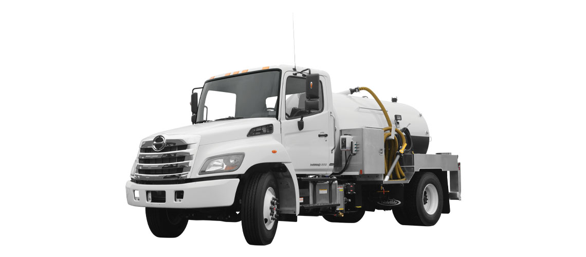 White MD 1600 vacuum truck with a large cylindrical tank and a hose attachment.