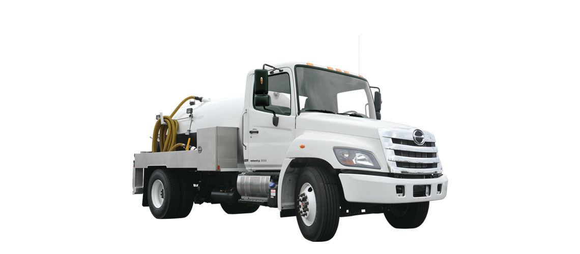 White industrial truck with large tank and coiled yellow hoses on flatbed against white background.