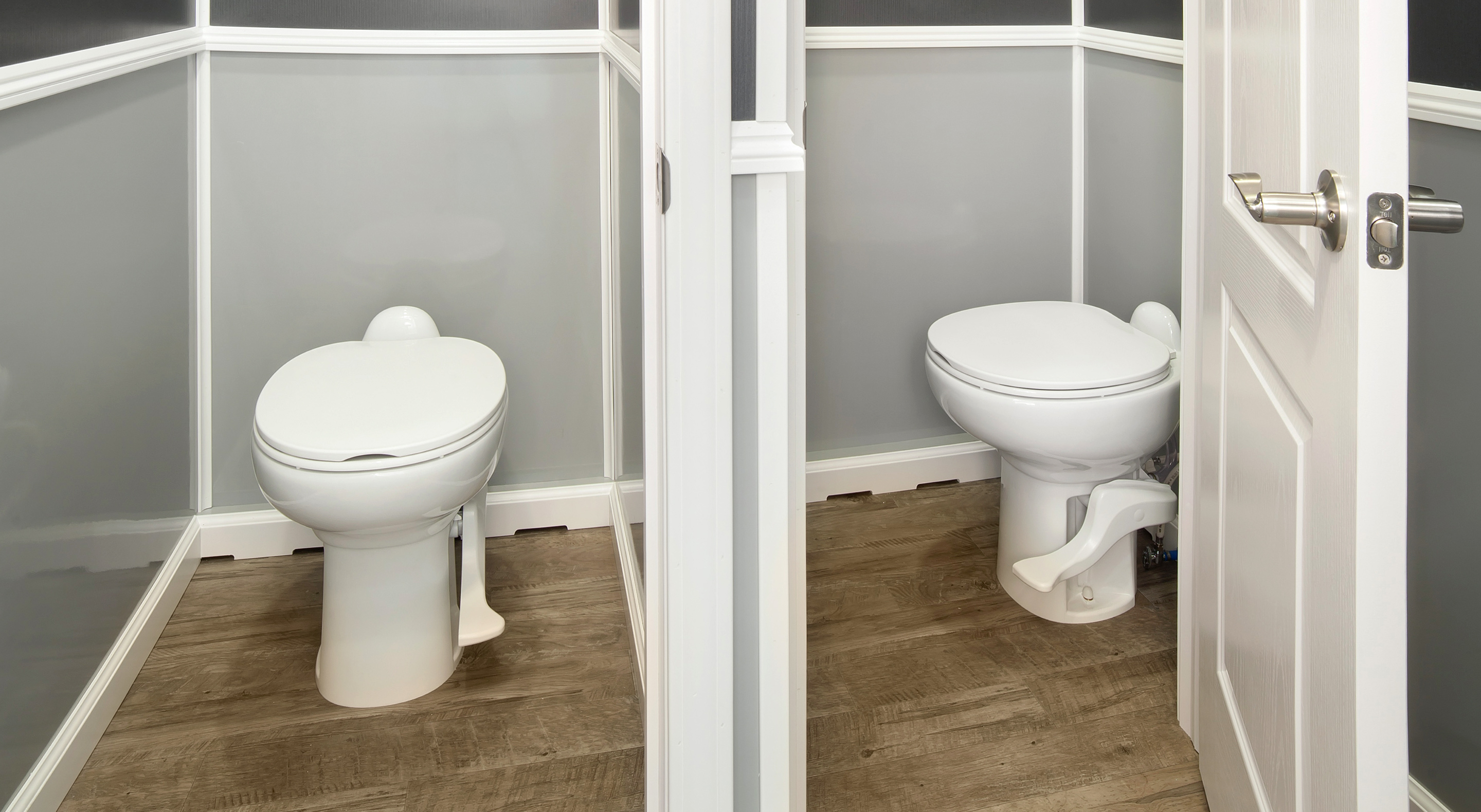 Clean white toilet with foot pedal flush in a small, paneled bathroom with wood-look flooring.
