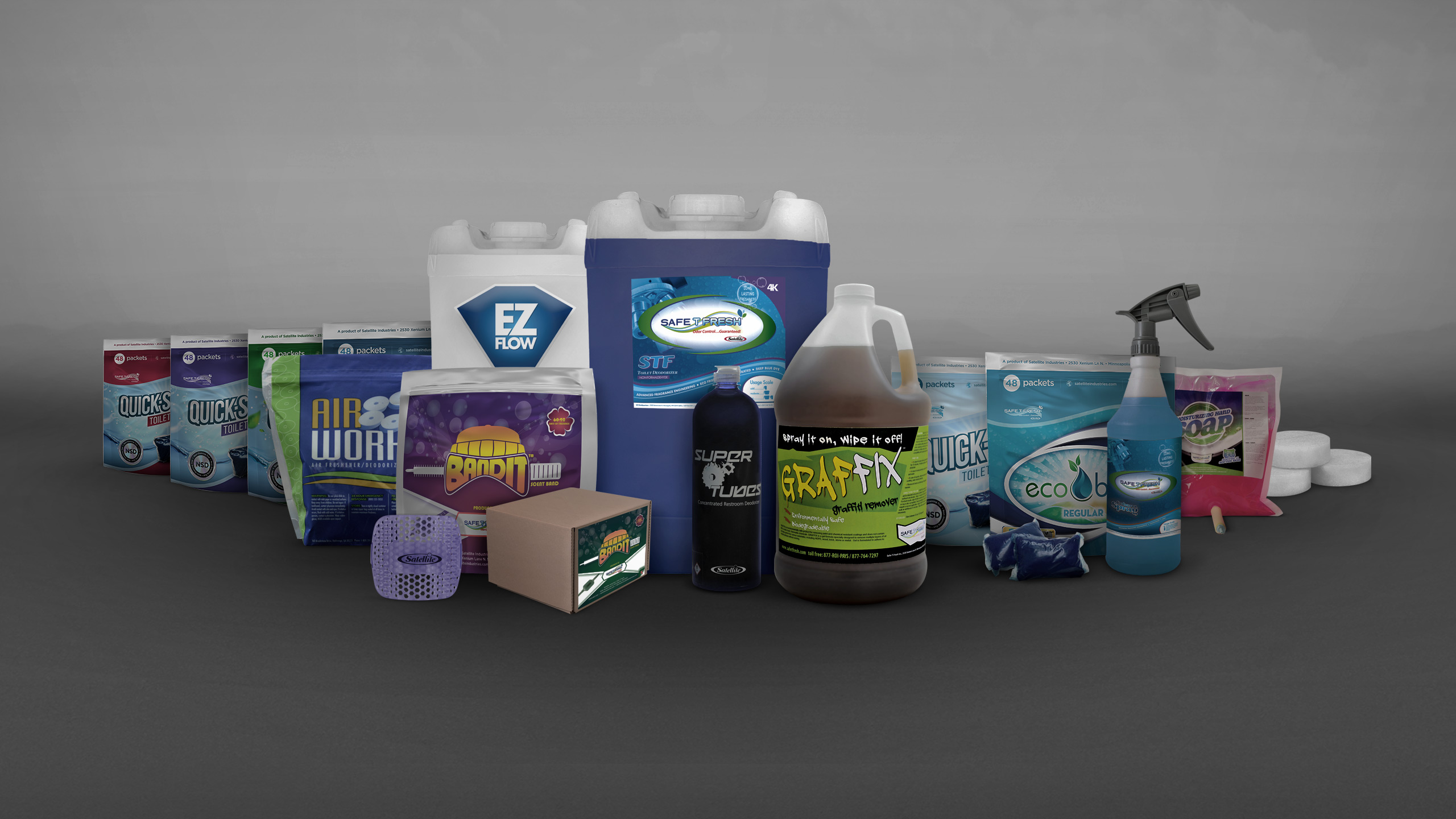Various cleaning and deodorizing products including sprays, powders, and packets arranged on a gray surface.