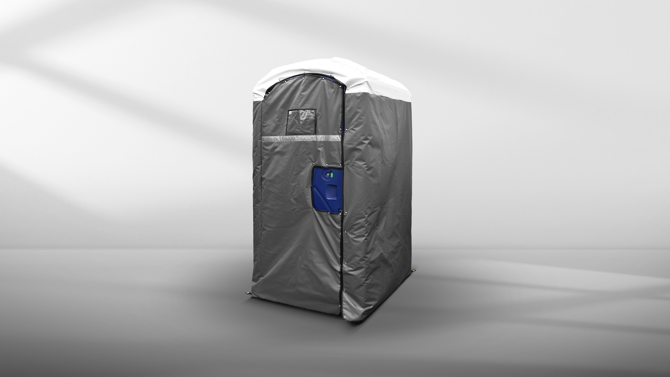 Insulated portable restroom cover in gray with white roof on a neutral gray background.