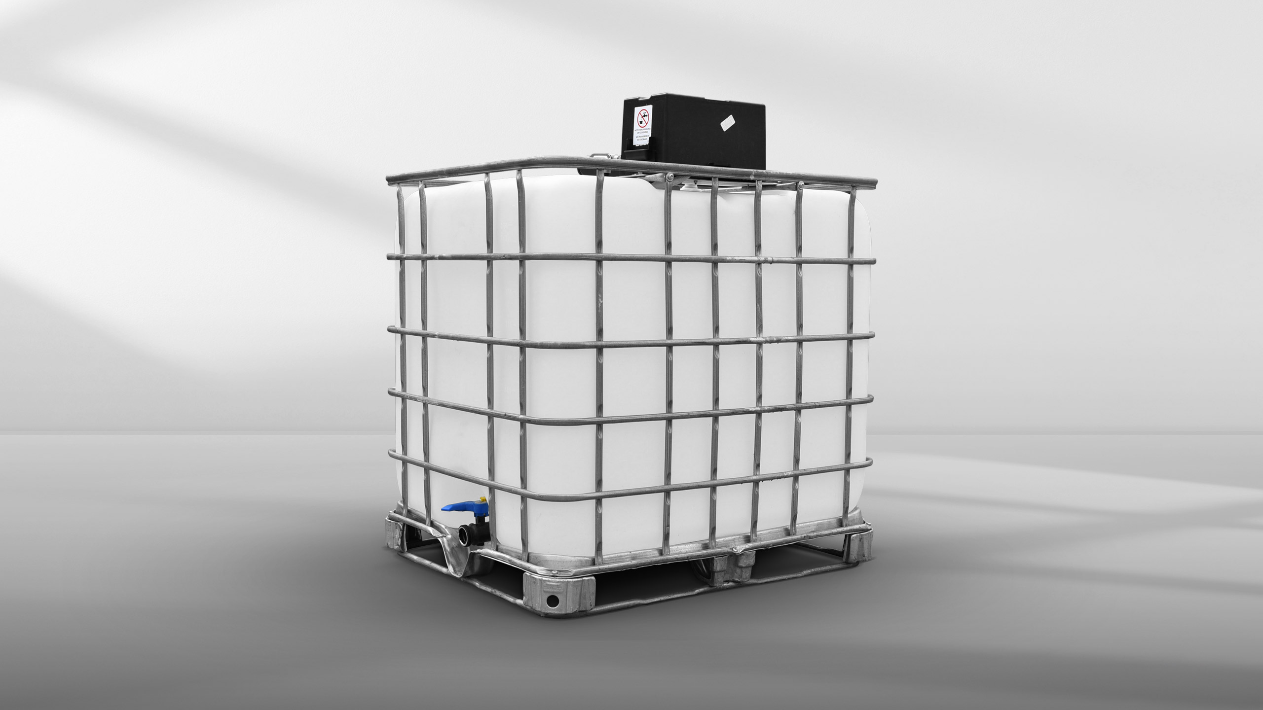 Large white industrial water container with metal cage and blue valve on a gray surface.