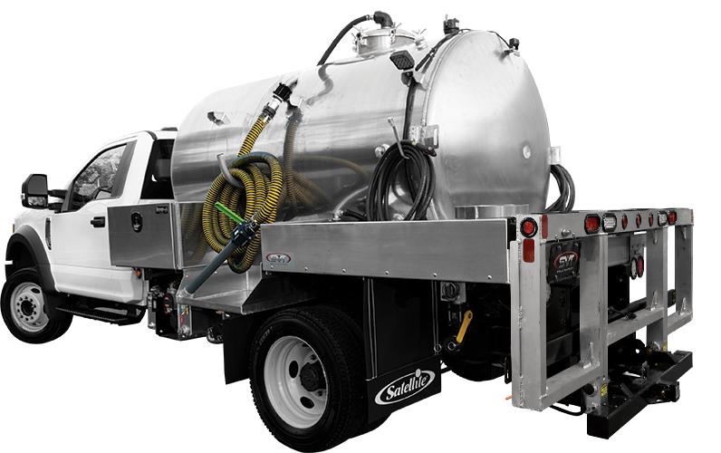 White industrial vacuum truck with large metal tank and attached yellow hoses.