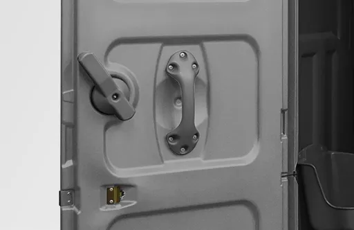 Close-up of a dark plastic portable restroom door with handle, latch, and lock mechanism.