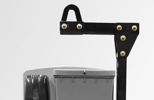 Black metal frame with bolts above a gray container and black dispenser on a white background.