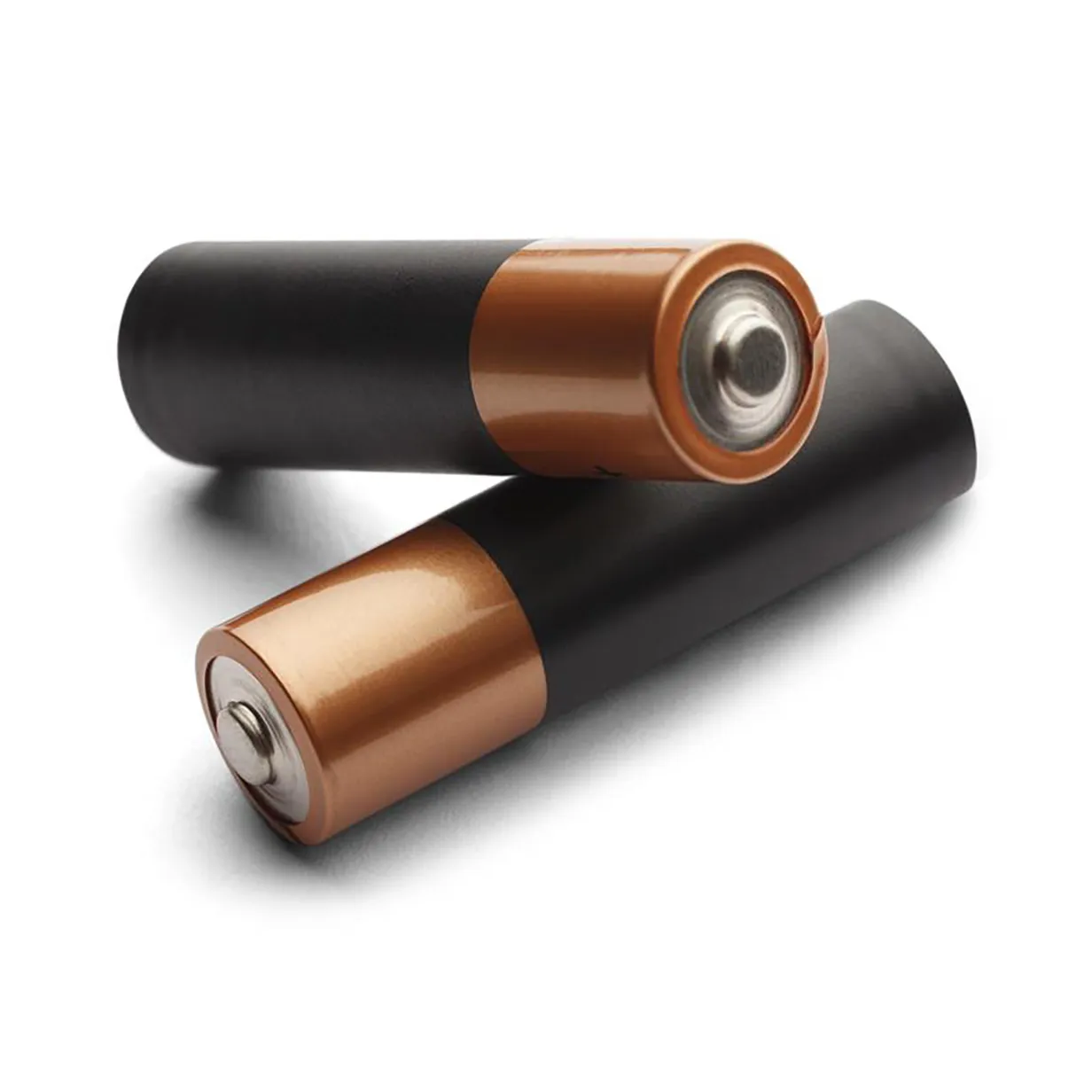 Two AA batteries with black bodies and copper-colored tops lying on a white surface.