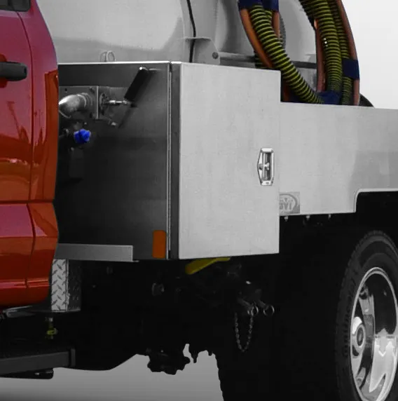 Close-up of a red utility truck’s rear with metal storage box and coiled hoses.