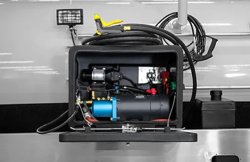 Open compartment showing a mounted air compressor with coiled air hose inside a truck body.
