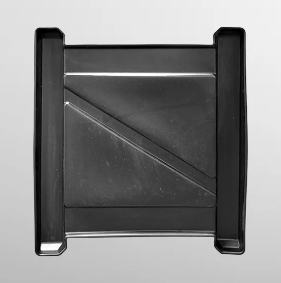Black plastic square item with raised edges and diagonal ridge in the center on a gray background.