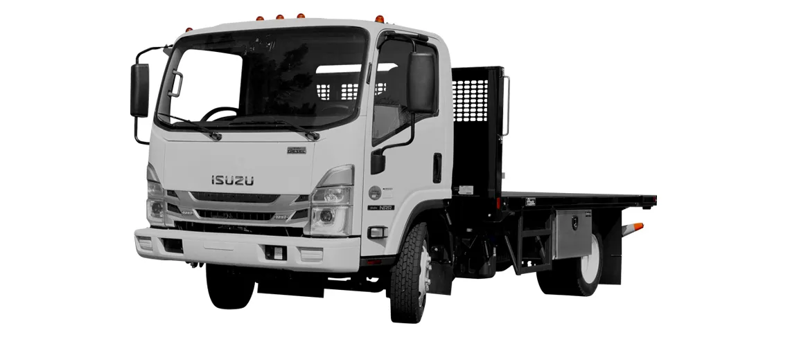 Isuzu flatbed truck with a fenced cargo area, designed for transporting materials.