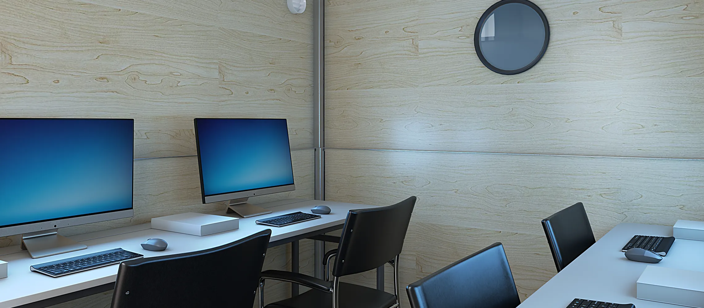 Modern office with two desks, four black chairs, and computers with blank blue screens.