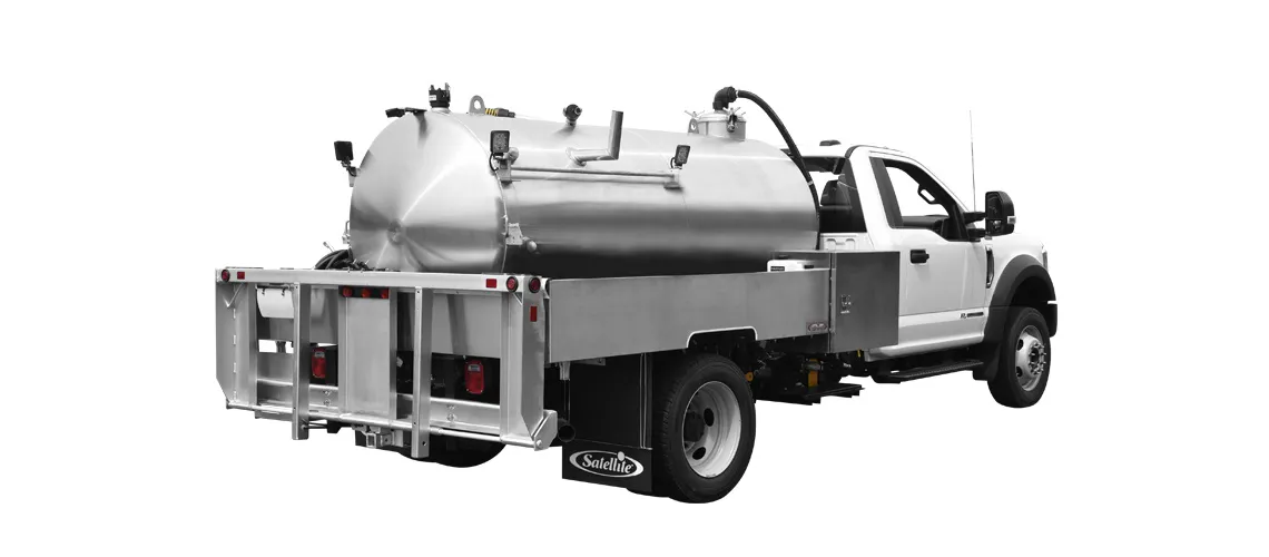 White flatbed truck with a large stainless steel tank and equipment on the back.