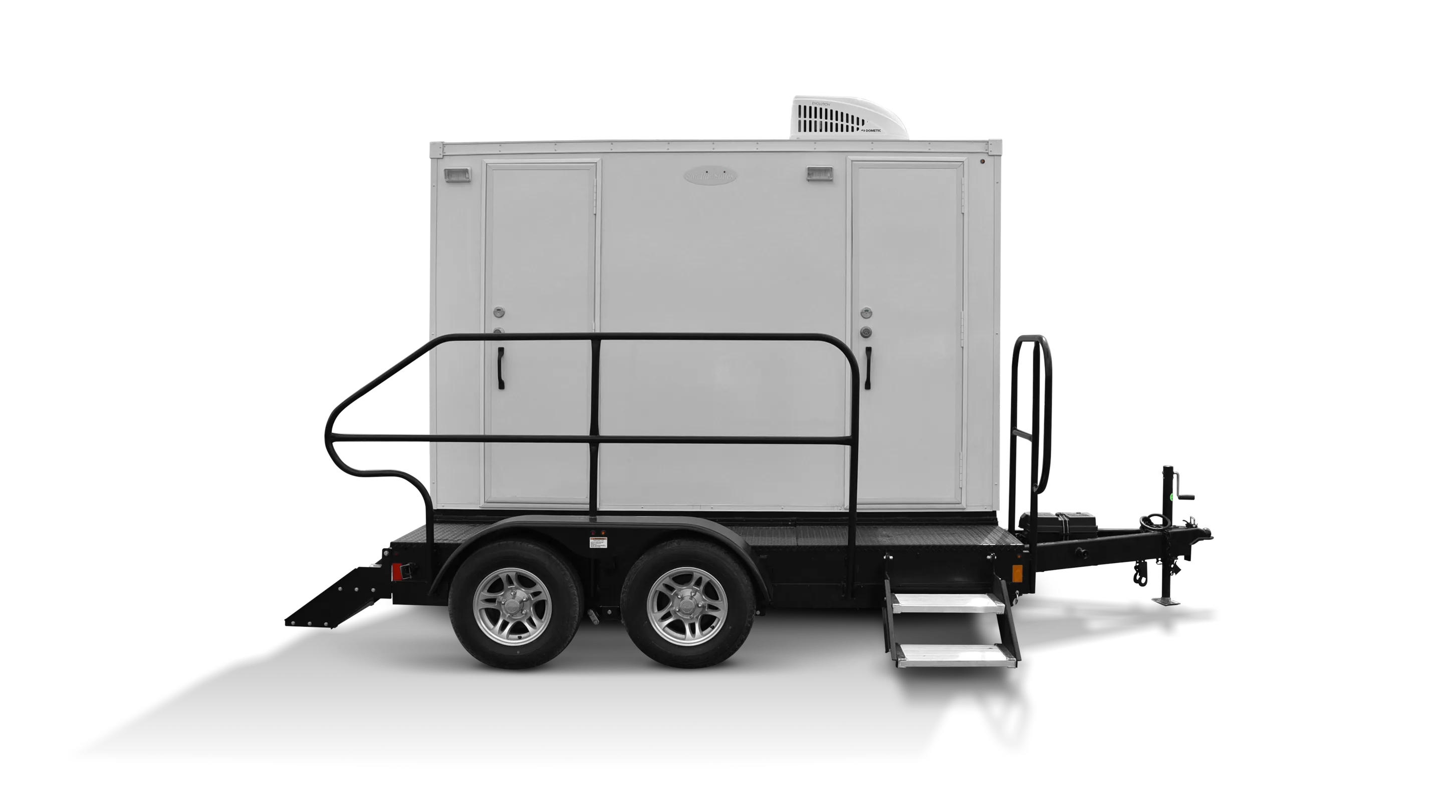White two-station restroom trailer on wheels with steps and handrails, ready for transportation.